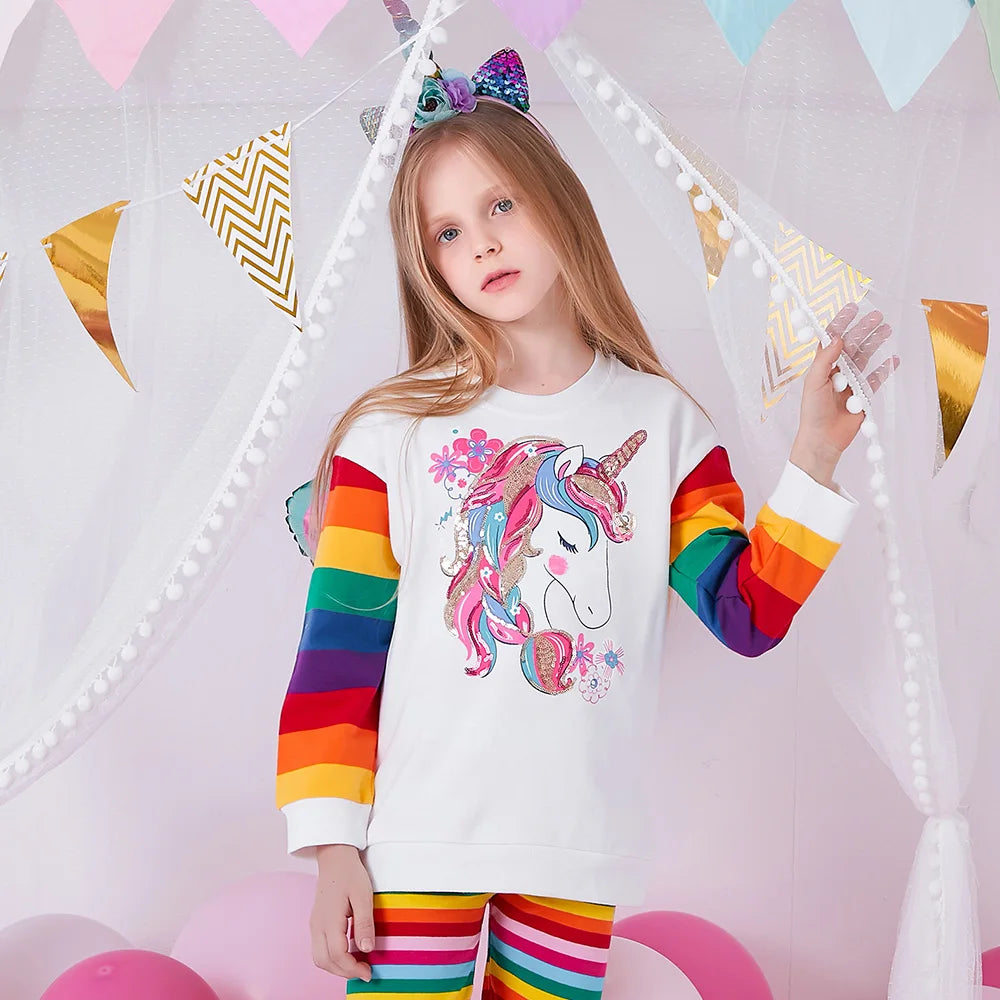 girl wearing unicorn rainbow sequin sweatshirt, colorful striped kids pullover