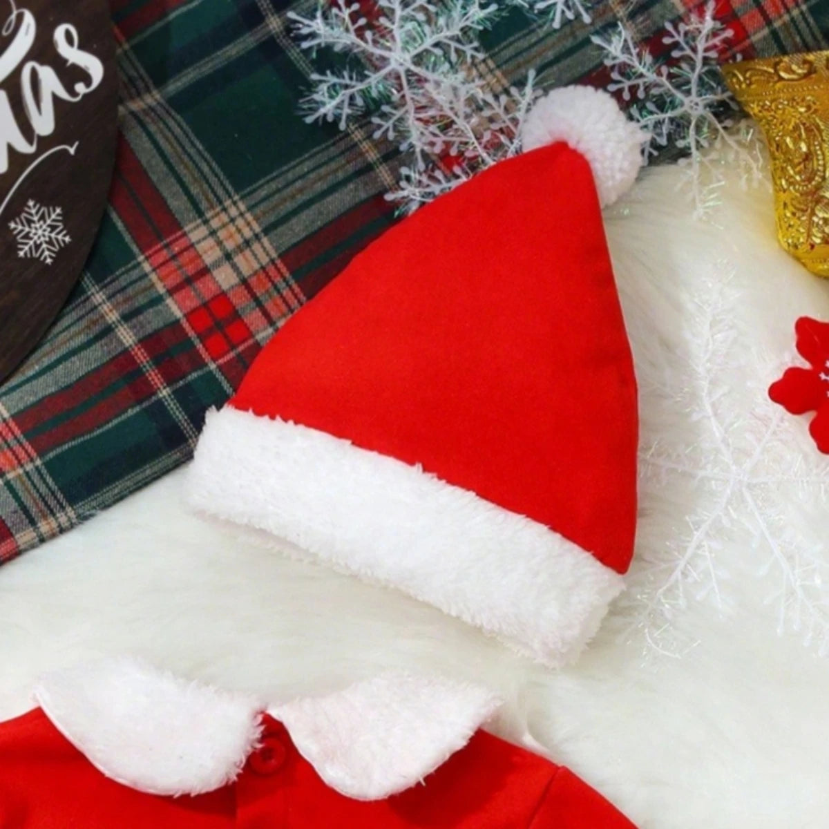 detailed view of red hat with white trim from baby outfit set